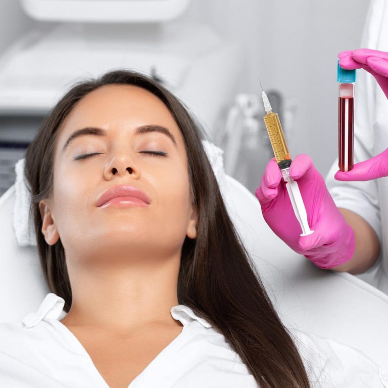 Beautician will do PRP therapy for the face against wrinklesand against hair loss of a beautiful woman in beauty salon.Doctor holds test tubes with venous blood and blood plasma.Cosmetology concept.